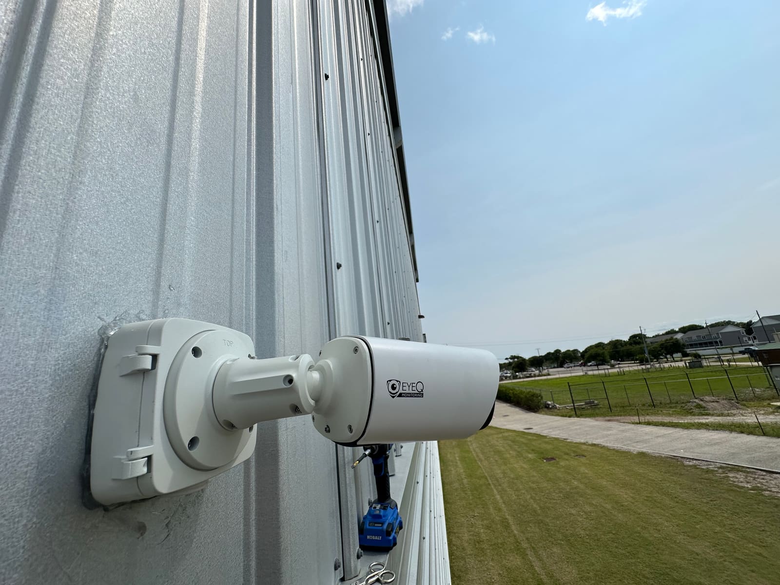 Bullet surveillance camera overlooking an open field