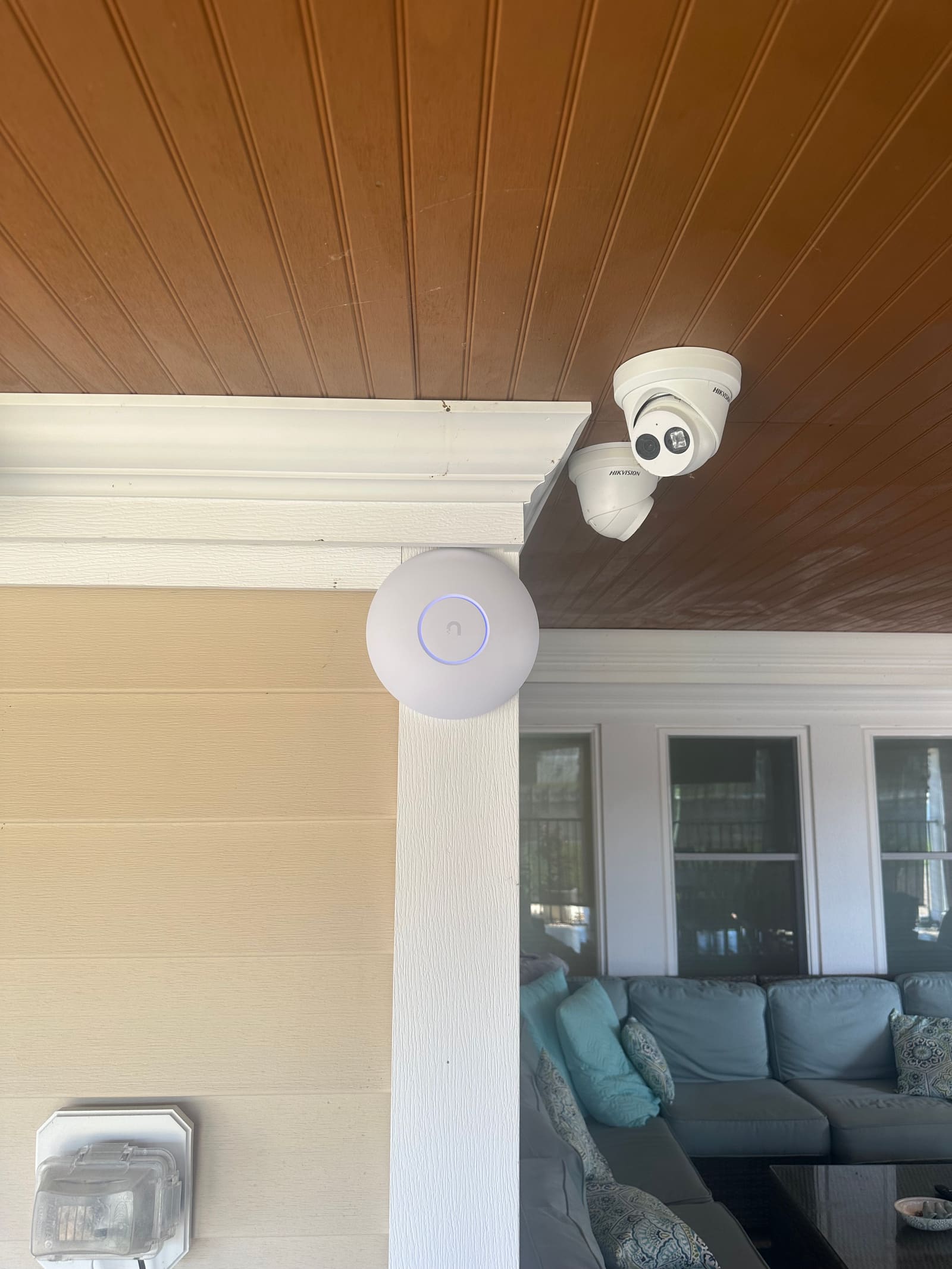 Turret security camera mounted on a beach house porch ceiling