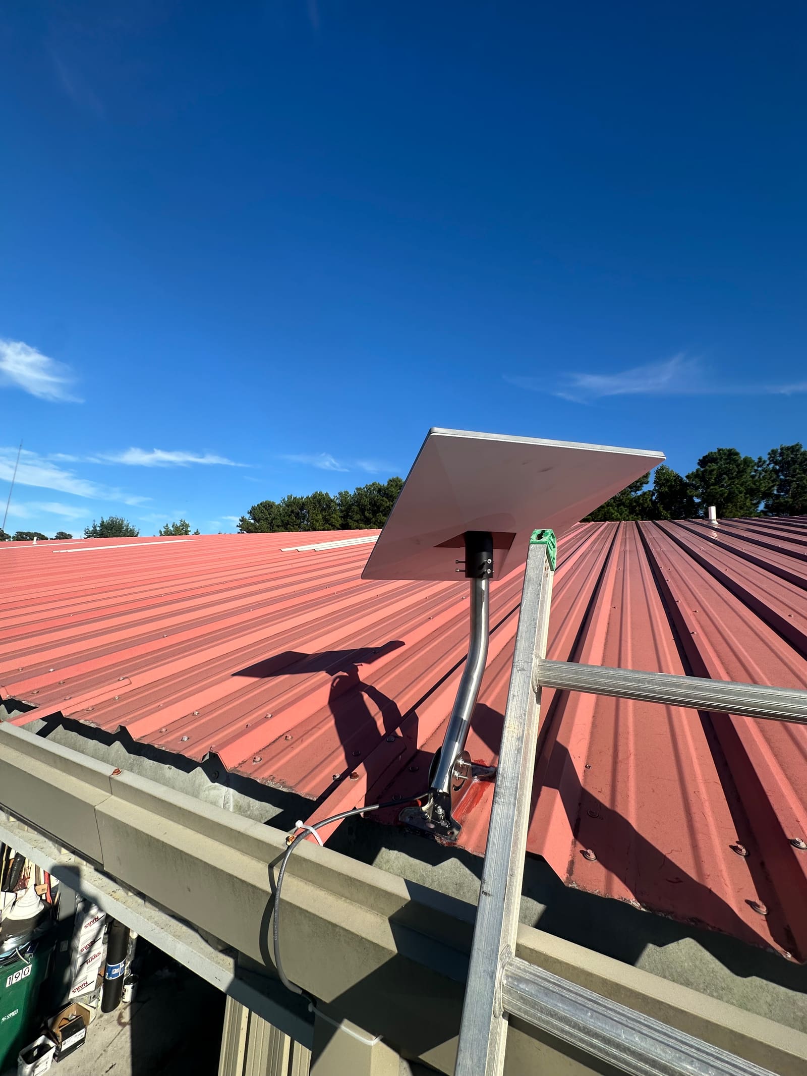 Satellite internet dish on a metal roof connecting a remote camera site